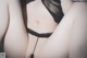 A close up of a woman wearing a black lingerie.